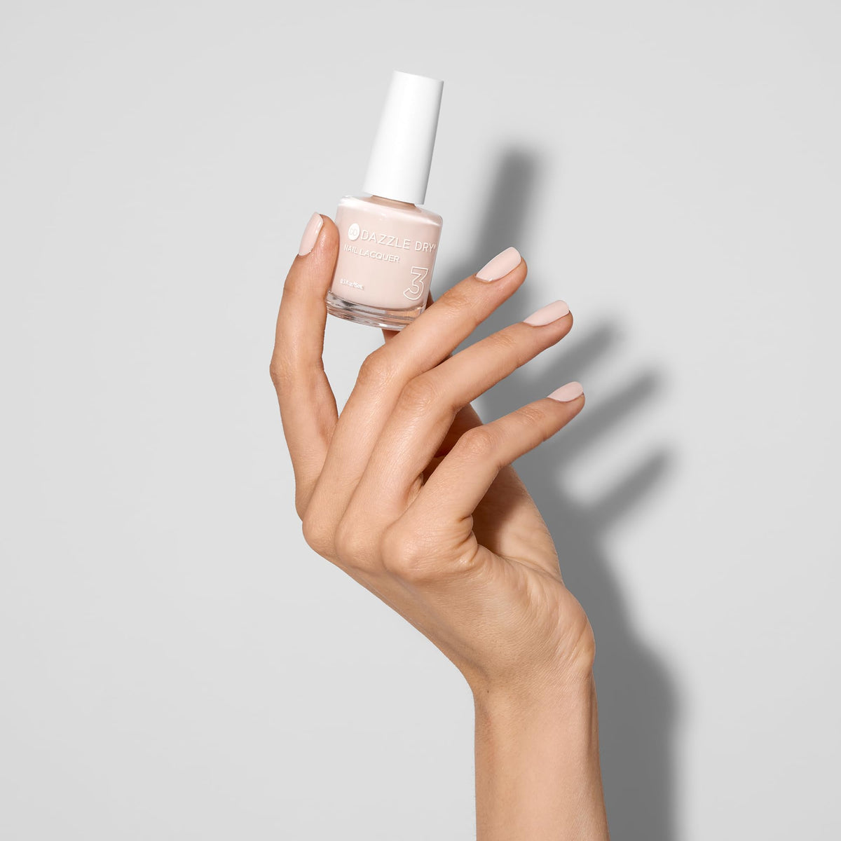 Swatch on fingers wearing So On Pointe demonstrating subtle, wearable finish