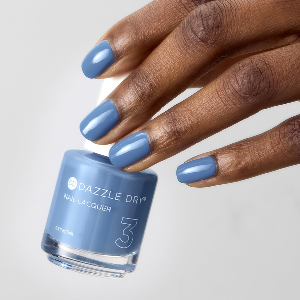 Close-up of Dazzle Dry on nails showing clean denim cream manicure benefit
