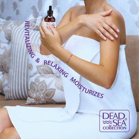 Dead Sea Collection two 4 fl oz bottles held to show true scale