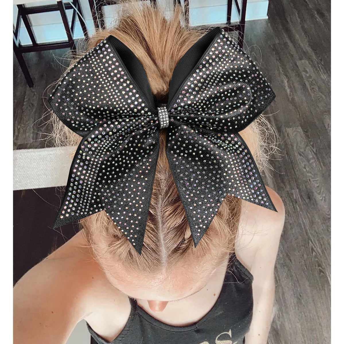 DEEKA cheerleader wearing bow in ponytail for performance-ready look