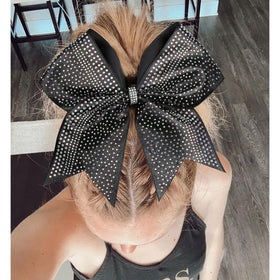 DEEKA cheerleader wearing bow in ponytail for performance-ready look