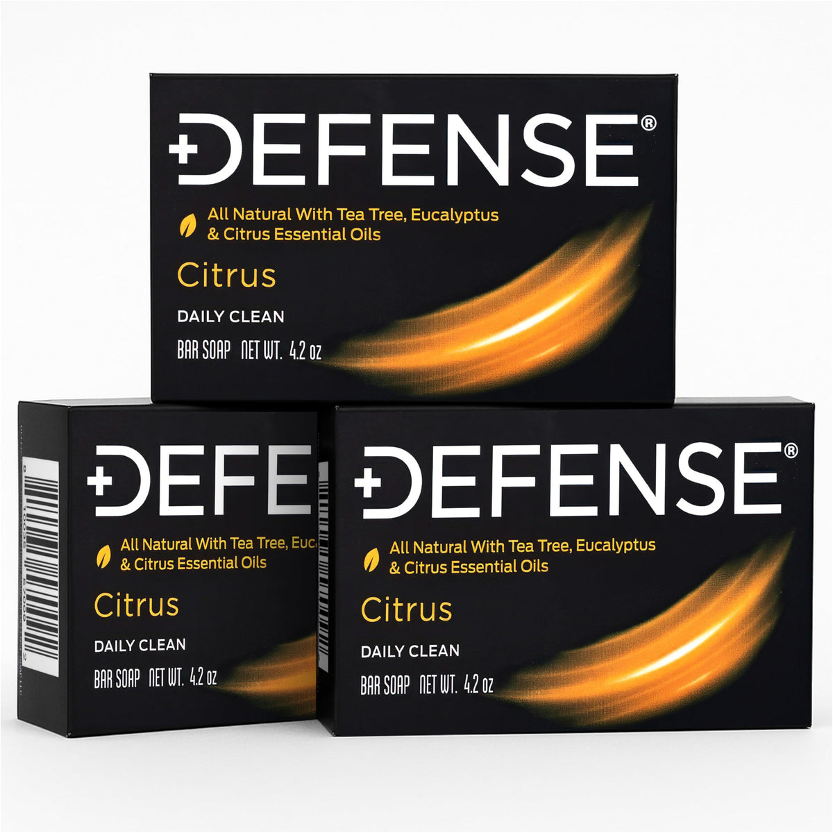 Defense Soap citrus bar next to hand for scale showing compact travel size