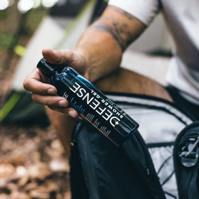 Athlete using Defense Soap in a shower to rinse sweat and refresh skin after training