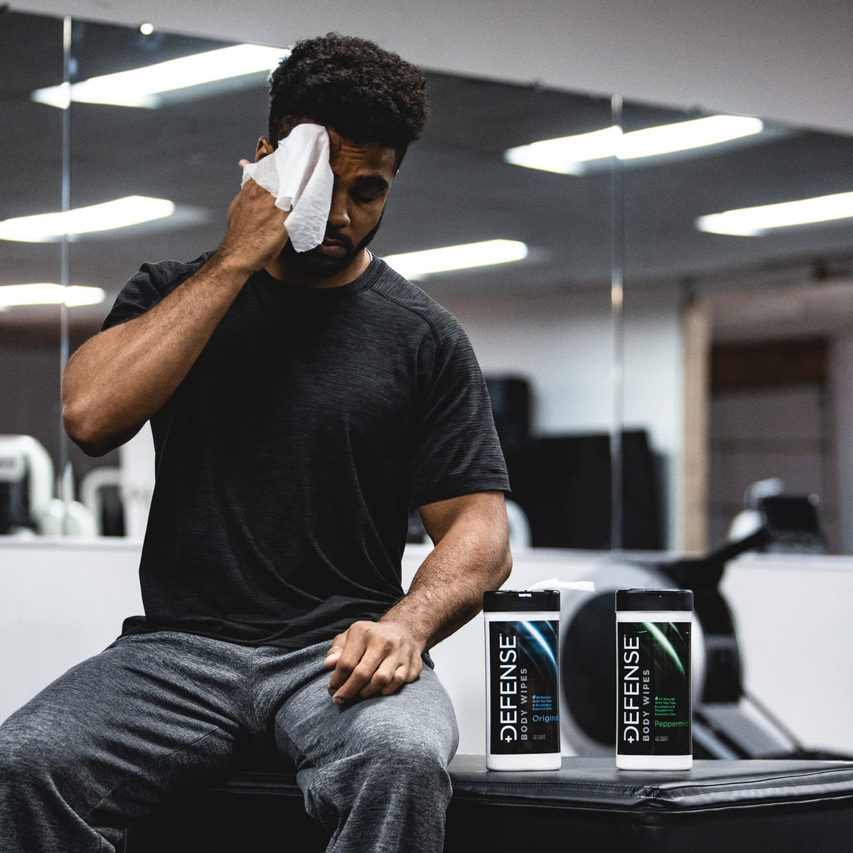 Pack of Defense Soap wipes beside a gym bag for convenient on-the-go hygiene
