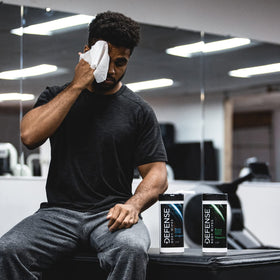 Pack of Defense Soap wipes beside a gym bag for convenient on-the-go hygiene