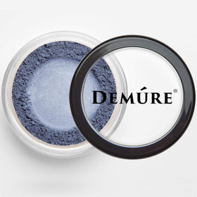 DEMÚRE size comparison with compact to show scale and portable travel-friendly benefit