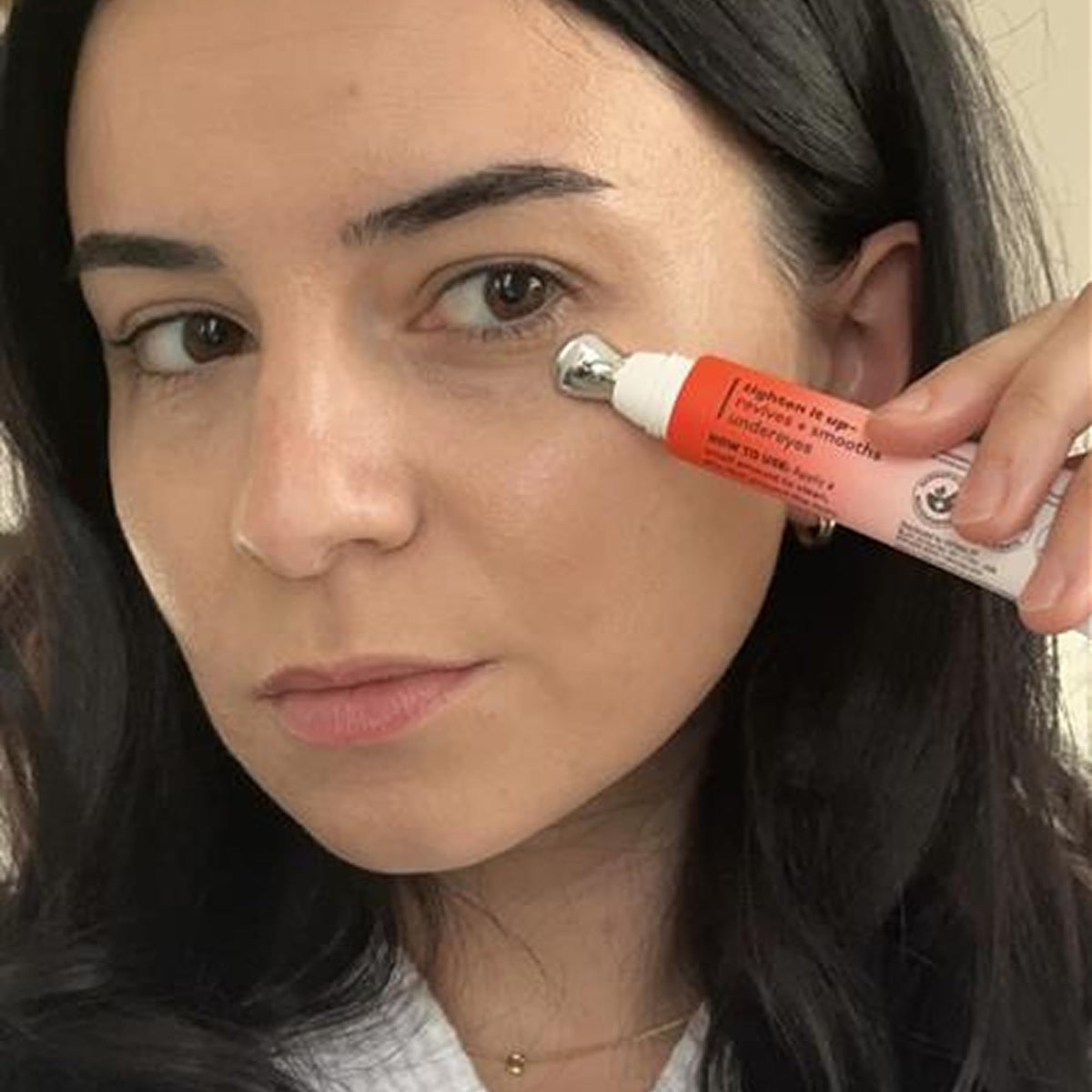 Derma E product beside ruler showing 0.5 fl oz compact travel-friendly size