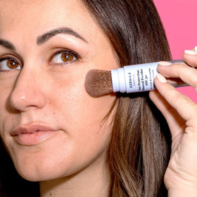 DERMA E brushed along hairline demonstrates scalp sun protection
