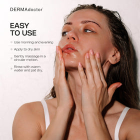 DERMAdoctor bottle in hand to show size and travel-friendly scale