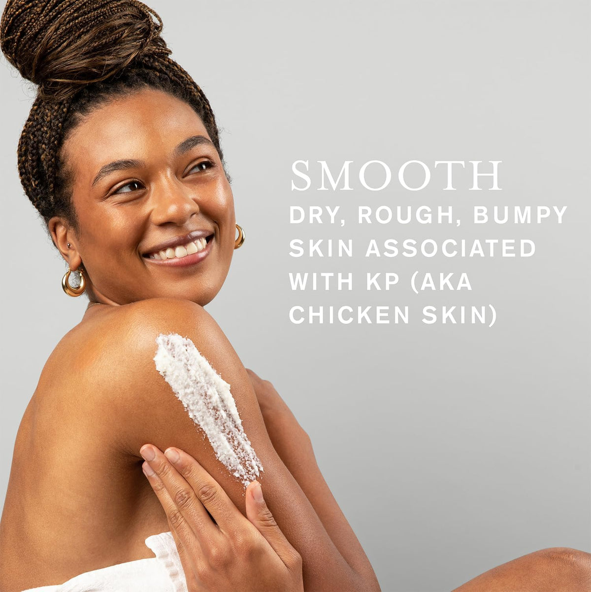 Hand applying DERMAdoctor scrub to arm to reduce bumps and roughness