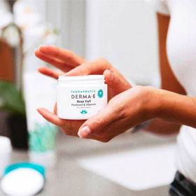 Derma E tube on bathroom shelf in a clean skincare routine scene