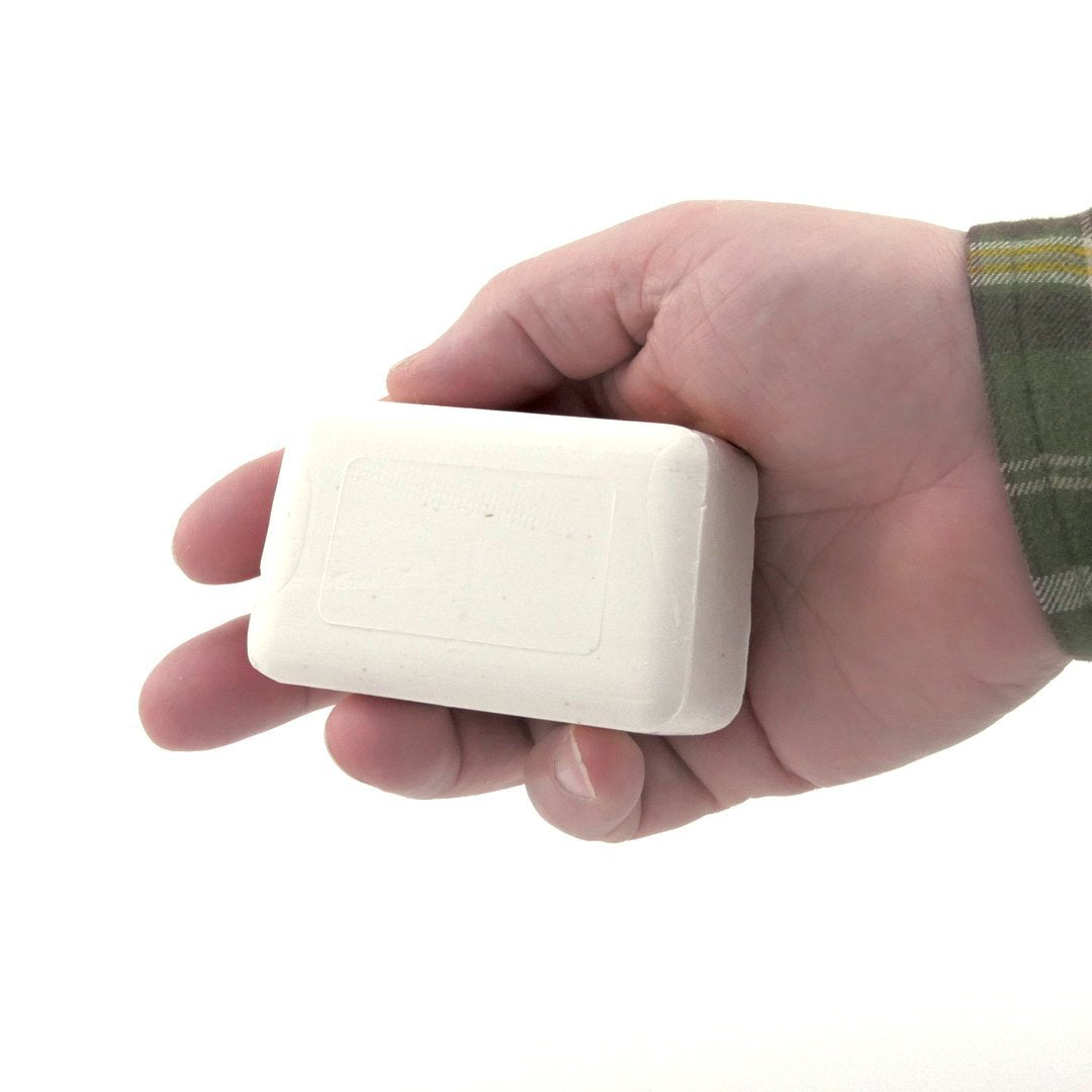 Dermaharmony bar in hand showing 4 oz scale for easy portioning benefit