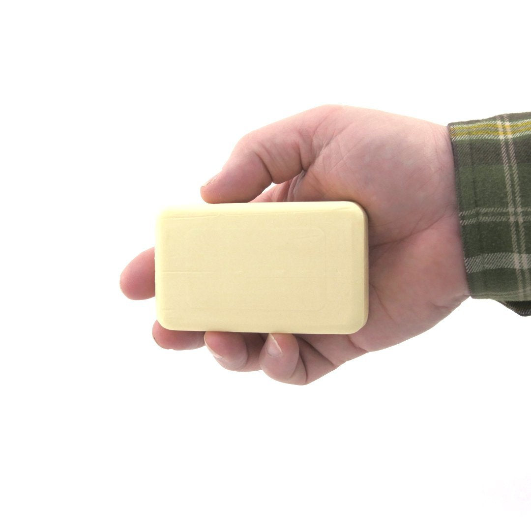 DermaHarmony bar held in hand to show actual size and portability