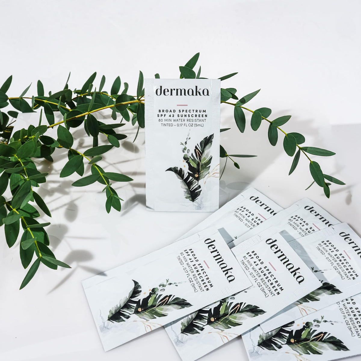 Dermaka sachet beside credit card illustrating compact travel benefit