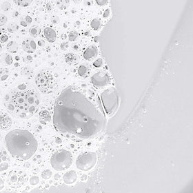 Dermalogica applied on hand in shower illustrating smooth cleansing