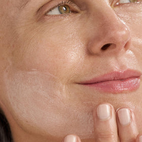 Dermalogica cream being applied on hand showing smooth spreadability benefit
