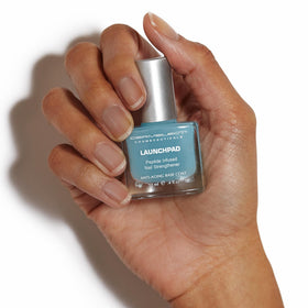 Dermelect Launchpad brush applying base coat to nail for fast-dry convenience