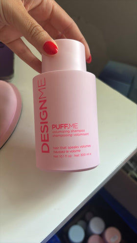 Design.Me bottle in hand for scale to show size and travel-friendly convenience