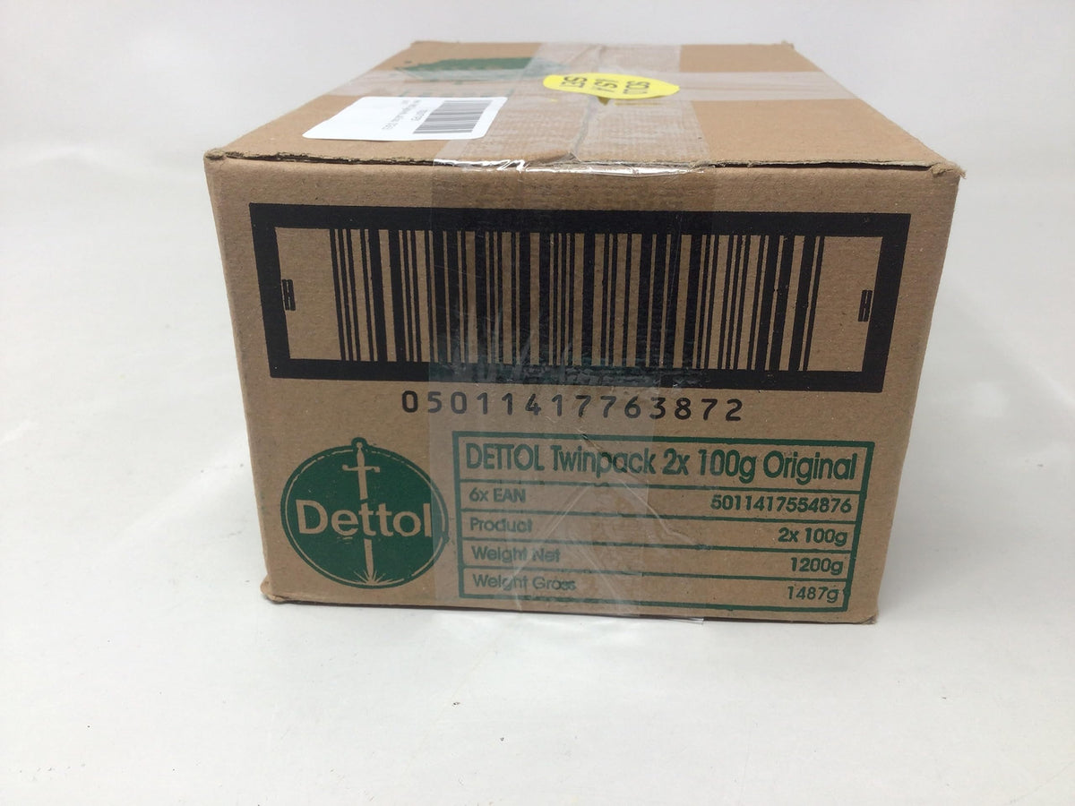 Dettol bar in hand for scale showing compact travel-friendly size