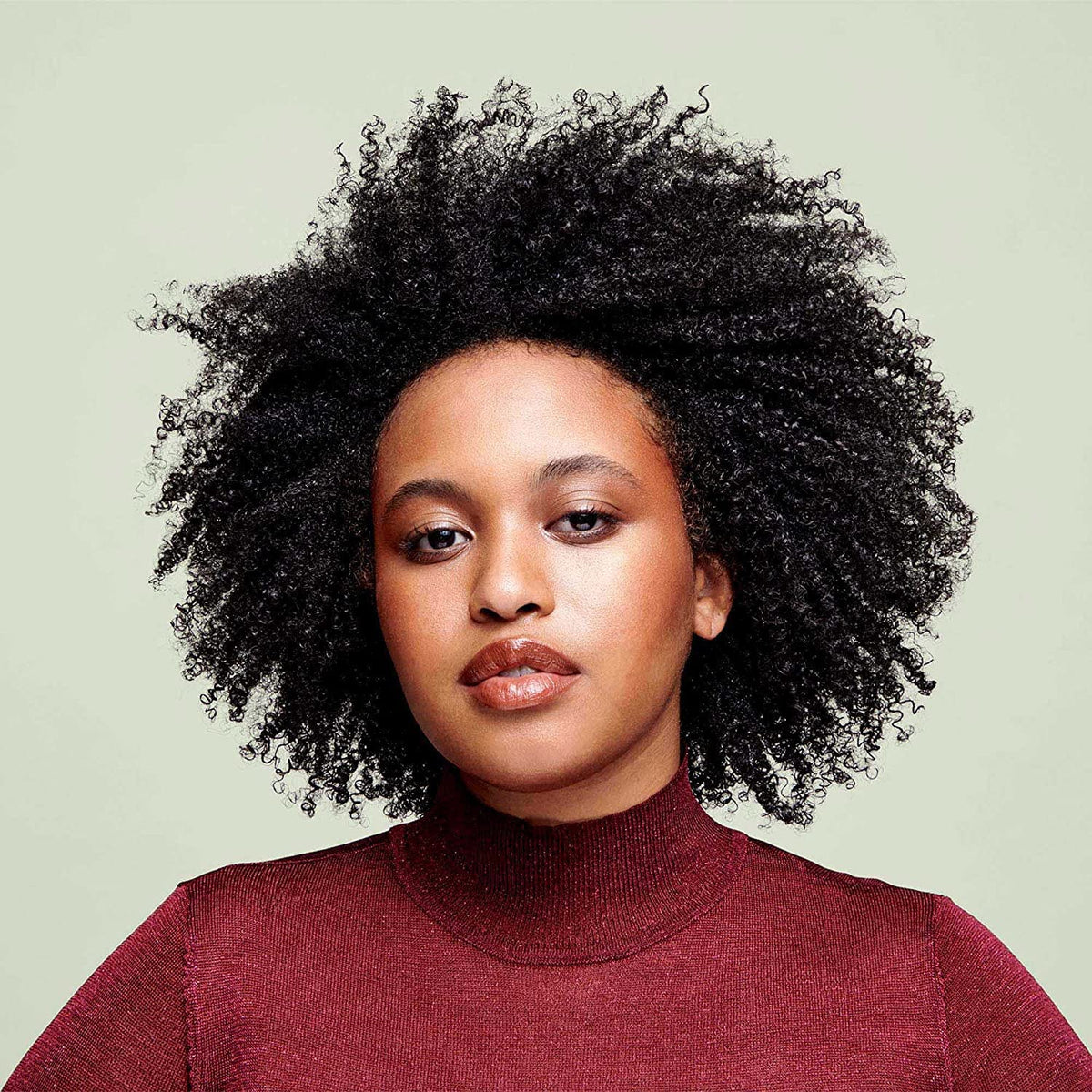 DevaCurl being applied to wet curls to improve manageability and reduce tangles