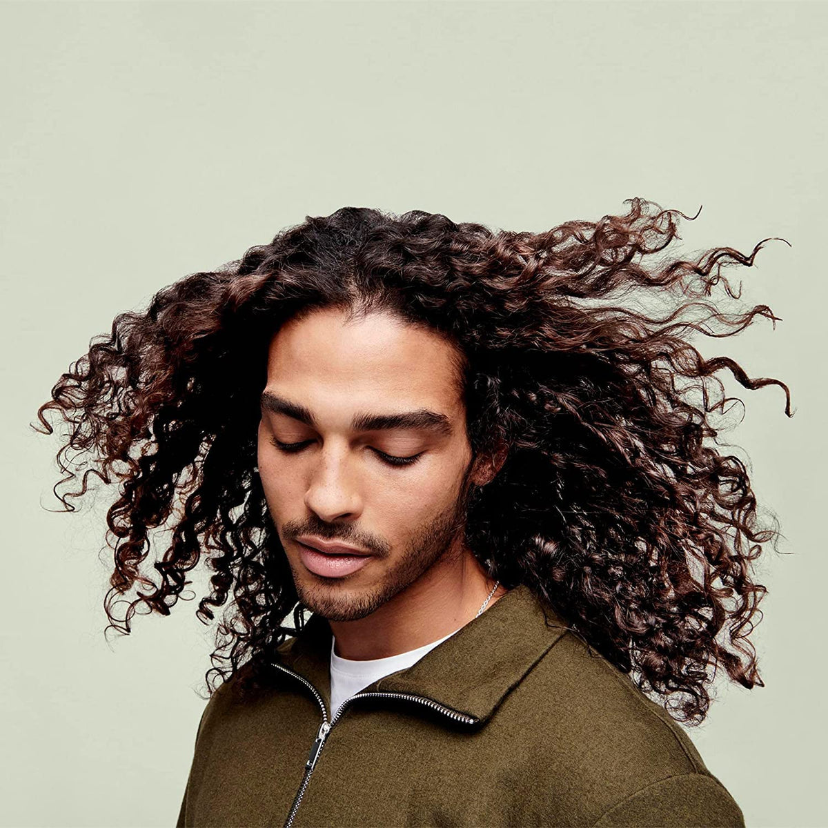 DevaCurl jar on shower shelf showing everyday use and frizz-reducing benefit
