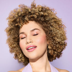 DevaCurl ingredient label close-up highlighting dermatologist co-developed formula and key benefits