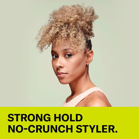 DevaCurl bottle in hand to show size and easy-at-home styling benefit