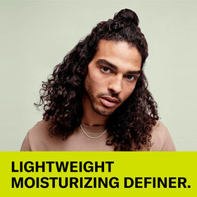 DevaCurl cream on fingertip demonstrating easy application and control