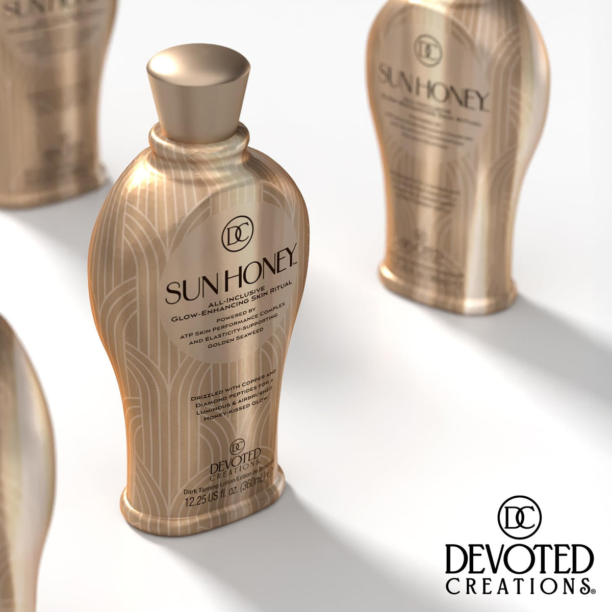 Devoted Creations Sun Honey bottle in hand for size and scale convenience