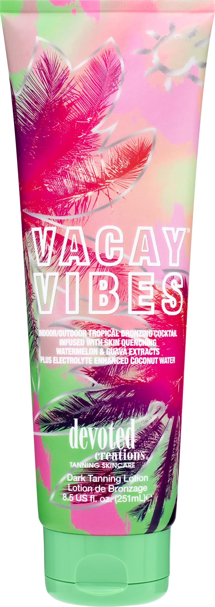 Devoted Creations bottle on beach towel evoking tropical scent and vacation hydration
