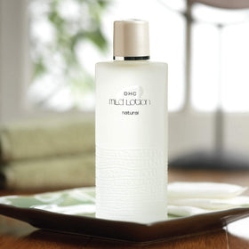 DHC bottle staged with serum and cream illustrating routine compatibility