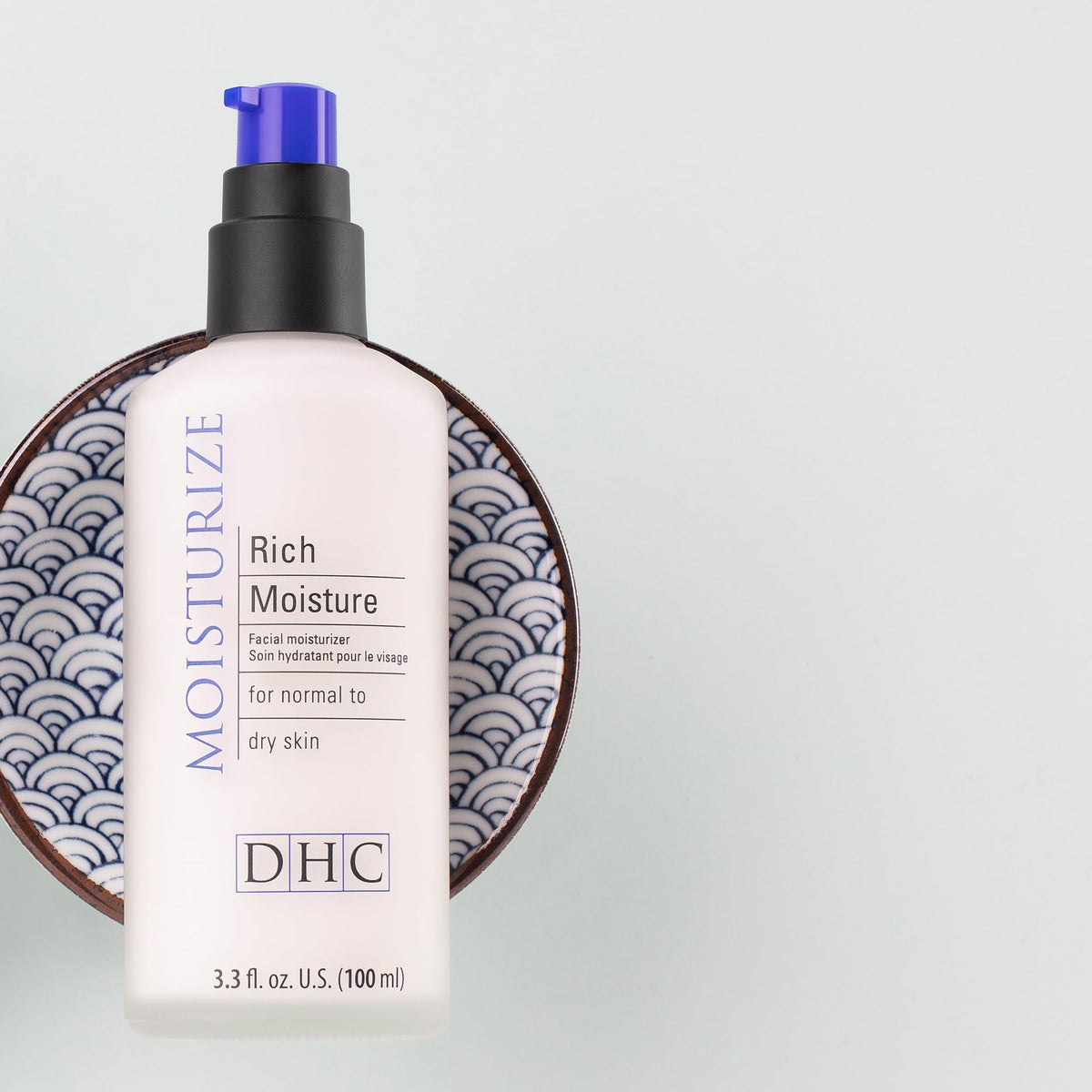 DHC Rich Moisture next to common bottle showing 3.3 fl oz scale