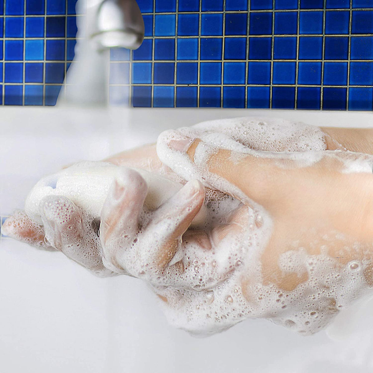 Hand holding lathered Dial Power Berries soap demonstrating rich moisturizing foam