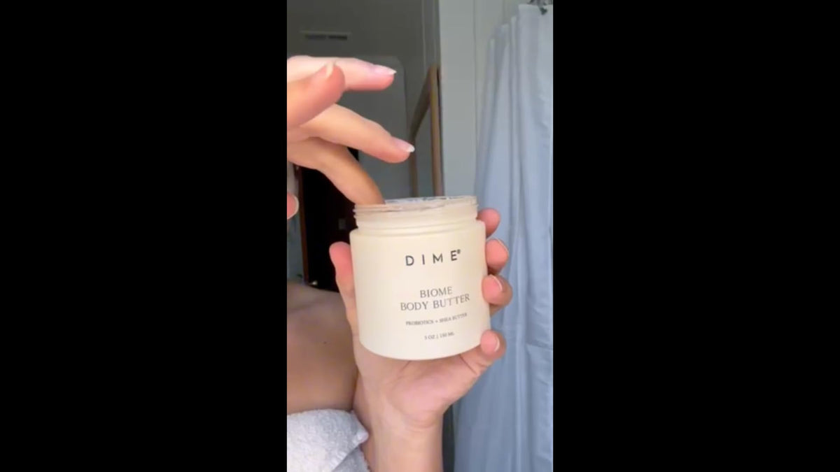 DIME jar next to a hand for scale showing compact 5 oz travel-friendly size