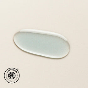 DIME blue facial oil applying to blemish area demonstrating targeted spot treatment