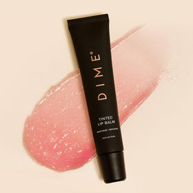 DIME Desert Rose on bedside table suggesting nighttime lip repair routine
