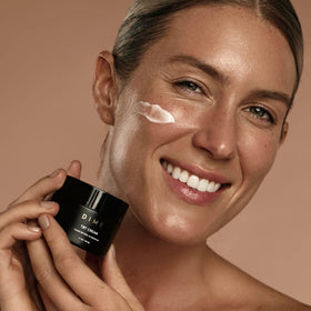 DIME TBT Cream being applied to cheek close-up showing lightweight absorption benefit
