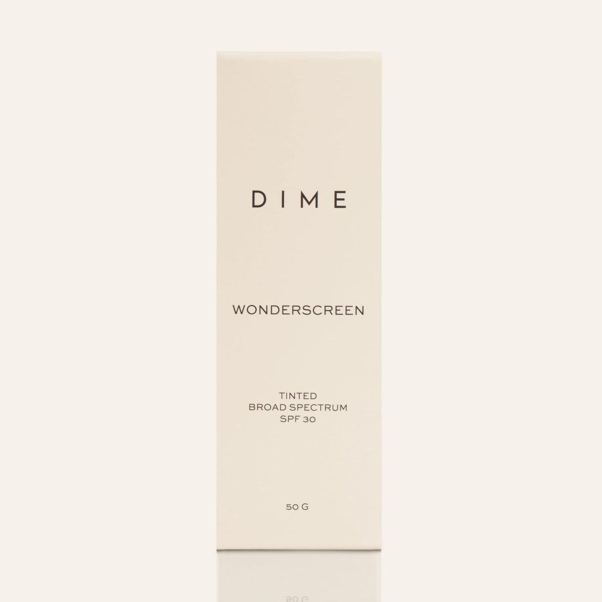 DIME tube next to a 50 g scale showing compact travel-friendly size