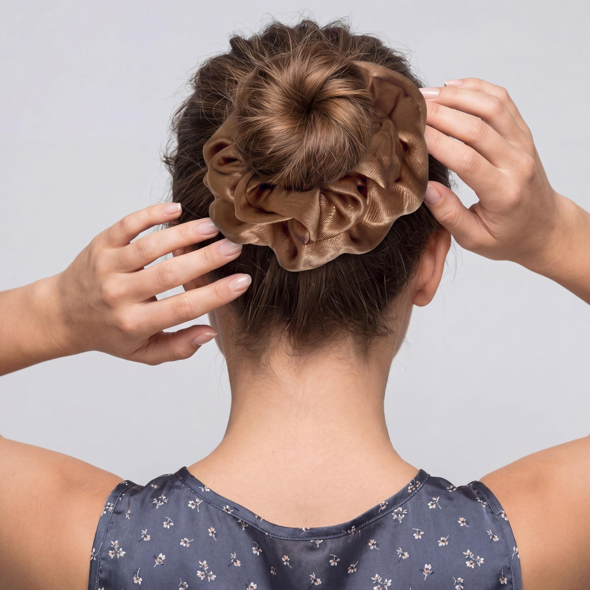 Dingion scrunchies held in hand to show scale and quantity for convenience