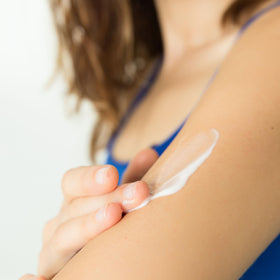 Dionis hand applying cream demonstrating targeted moisturization benefit