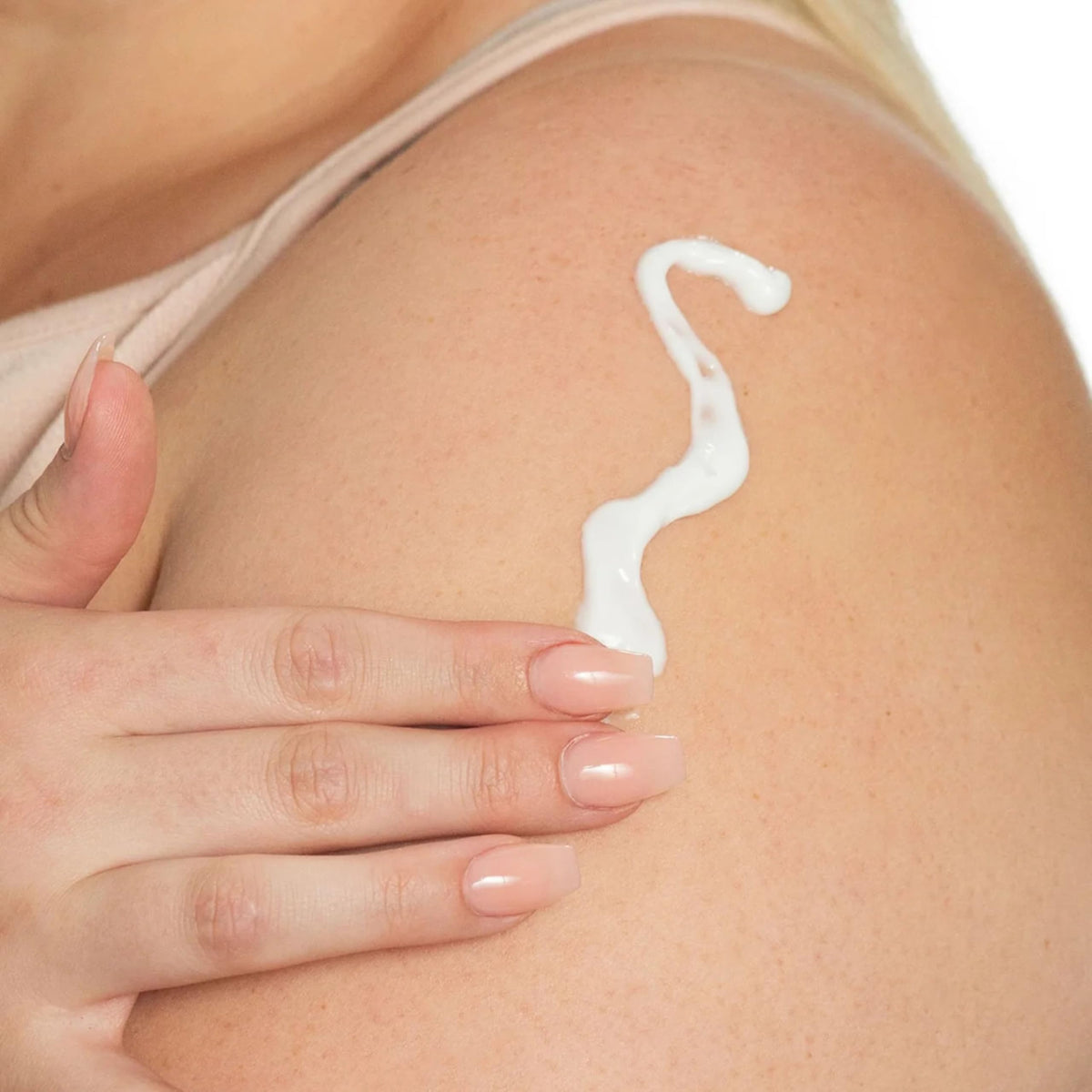 Dionis lotion texture swatched on palm showing creamy absorption and smoothing benefit