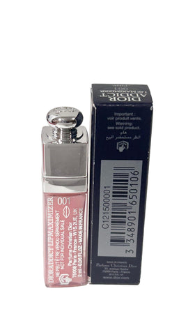Dior Addict mini next to a coin showing scale and pocket-friendly size