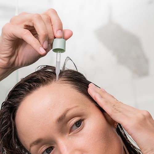 divi serum on bathroom shelf with towel, suggests easy daily routine integration
