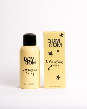 Dom Dom front bottle view showing label and volume, clear product benefit