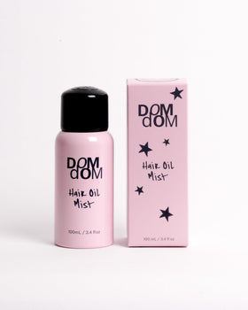 Dom Dom front bottle view showing label and compact 3.4 fl oz size for travel
