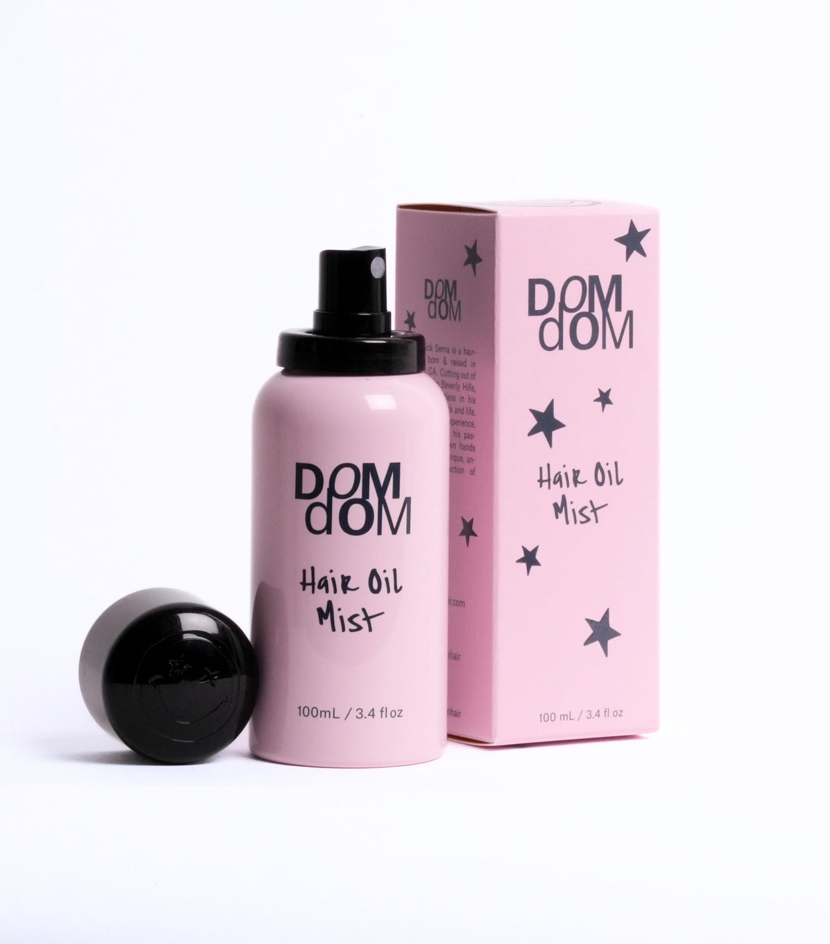 Dom Dom bottle spraying fine mist demonstrating even lightweight coverage