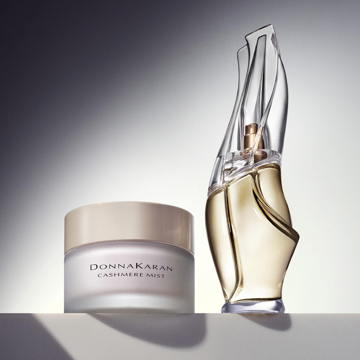 Donna Karan Cashmere Mist next to common items to show 5.9 fl oz scale