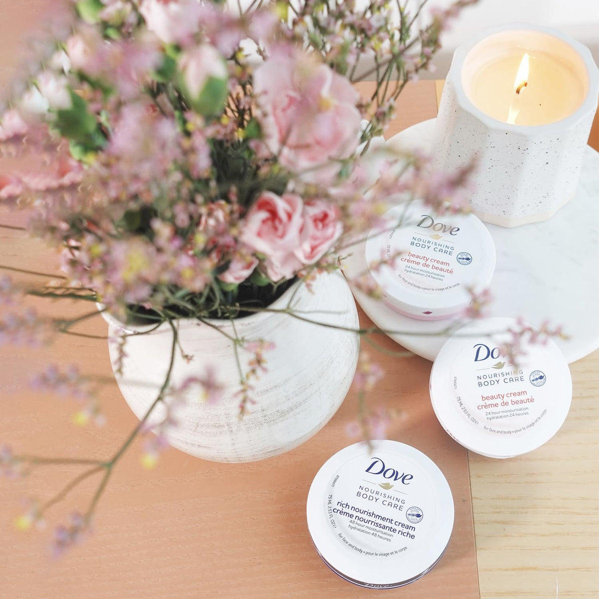 Dove jar next to passport showing travel-size convenience and 24-hour moisture