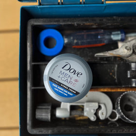 Dove Men+Care cream on palm illustrating easy application and non-greasy feel