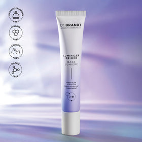 Dr. Brandt primer next to measuring cup for scale, clarifying 1 fl oz travel-friendly size